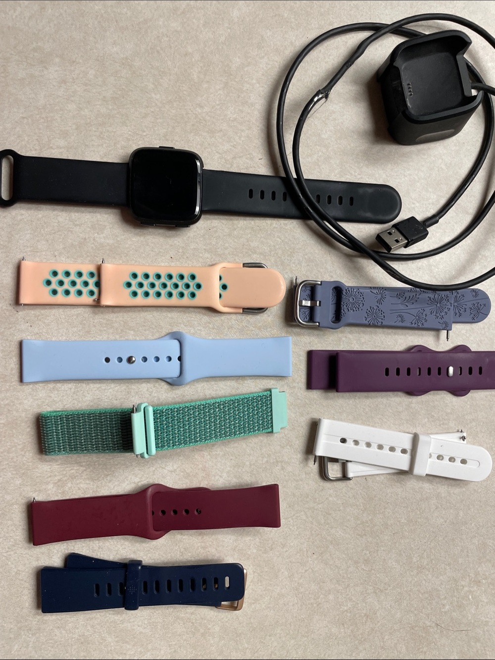 fitbit Smartwatch with Assorted Colored Bands and Charger